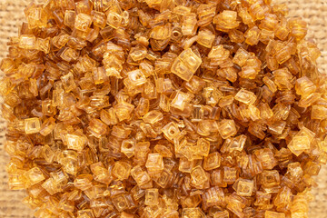 Yellow gelatin granules, macro, top view.