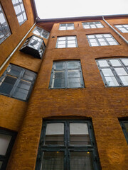 The old Copenhagen houses as seen from the back alleys, with their original dark yellow colour and green window sill.