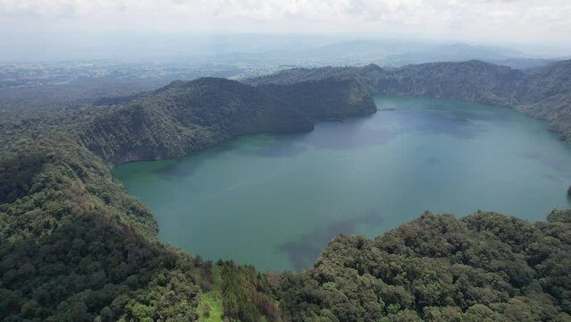 Ngozi lake in Mbeya, Tanzania. Drone view to second largest crater lake in Africa. Beautiful landscape surrounded by a bowl of high mountains.