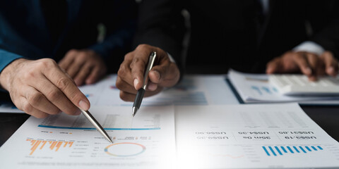 Business People Meeting using laptop computer,calculator,notebook,stock market chart paper for analysis Plans to improve quality next month. Conference Discussion Corporate Concept..