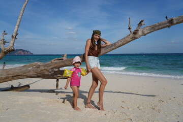 woman with her child on the beach in krabi thailand, poda island, model shooting 