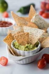 Homemade keto diet tortilla chips served with guacamole and salsa