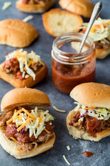 Toasted pulled pork sliders served with homemade tangy barbecue sauce.
