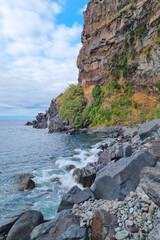 The waves of the ocean wash the coast of the island. The background of nature.