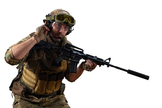 A professional mercenary soldier during a special operation calls for support on the radio while looking at the camera.