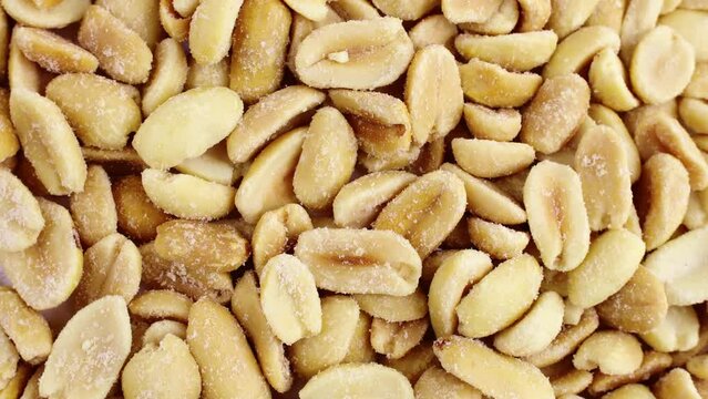 Top view of roasted salted peeled peanut nuts circle rotation close up