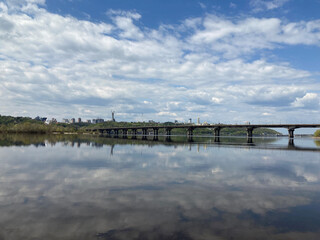 Obraz premium Kiev city bridge over the Dnieper river. Scenic view of the city landscape. The famous bridge. Residential buildings. view to the big river