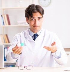 Young handsome doctor oculist working at the clinic