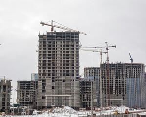 Fototapeta na wymiar Large-scale construction of multi-storey buildings in the city, new buildings, construction cranes