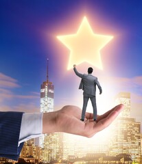 Businessman held on hand reaching out for stars