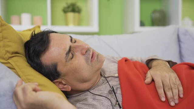 Bedridden sick man coughing at home, having a hard time. Sick and exhausted mature man in poor health, virus, tuberculosis, cancer,