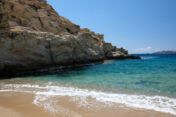 Fototapeta na wymiar The beautiful turquoise dream sandy beach of Sapounohoma in Ios Greece