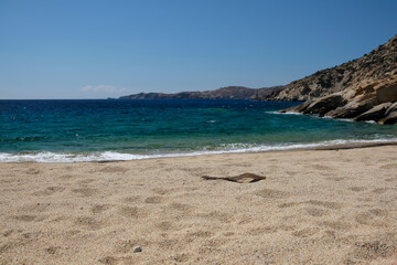Fototapeta na wymiar The beautiful turquoise sandy beach of Sapounohoma in Ios Greece