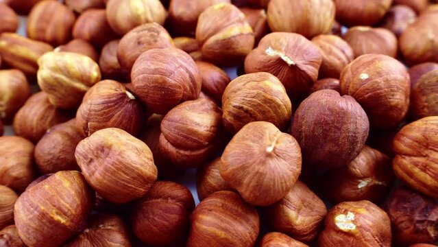 Peeled brown hazelnuts circle rotation close up