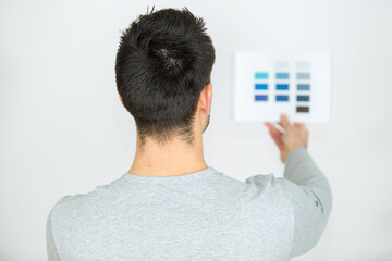 man looking at best color choice for wall