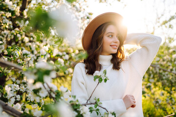 Young beautiful woman relaxing in blooming  garden. Spring,  romantic and lifestyle concept.
