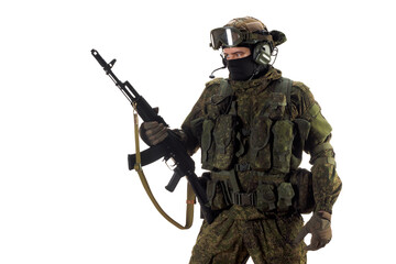 Cropped photo of a russian mercenary soldier with AK-74 in his hand and looking by side.