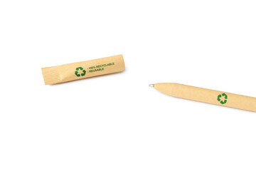 Zero waste and recycling concept. Disposable ballpoint pen made from recycled paper with a recycling sign. selective focus