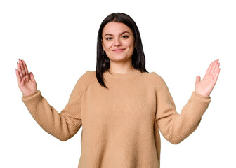 Young caucasian woman isolated holding something little with forefingers, smiling and confident.