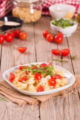 Orecchiette pasta with arugula and tomato.