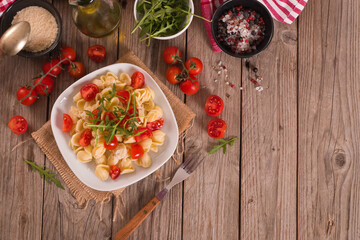 Orecchiette pasta with arugula and tomato.