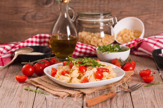Orecchiette pasta with arugula and tomato.