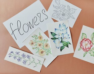 Photo of painted flowers on the table. Floral illustrations.
