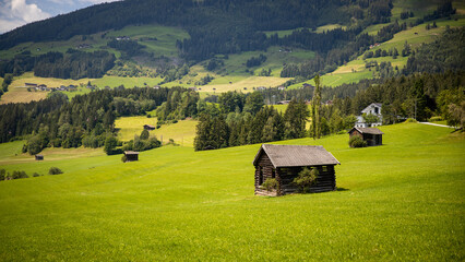solitary rustic camps for farmers in a green meadow
