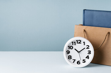 White plain analogue wall desk clock on blue background. Five past ten oclock. copy space, business schedule or agenda time management concept and opening or closing hours