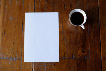 A4 mockup top view with cup of coffee on wooden table vertical