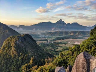 Fototapeta na wymiar Mountain at Vang Vieng Laos. Amazing tourist top spot, Hike through forest and mountain. High quality photo, Early Morning Sunrise time at Mountain in Vang Vieng Laos. Nature Sky Cloud Sun.