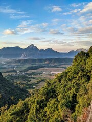 Early Morning Sunrise time at Mountain in Vang Vieng Laos. Nature Sky Cloud Sun. Mountain at Vang Vieng Laos. Amazing tourist top spot, Hike through forest and mountain. High quality photo