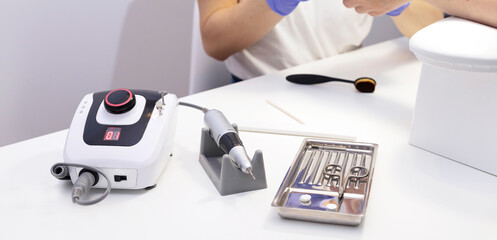 Banner set of nail tools. File, sterilized manicure scissors, electric hardware drill nail...