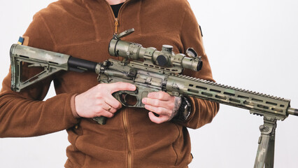 Soldier in a bulletproof vest with an American assault rifle, close-up details. Ukraine