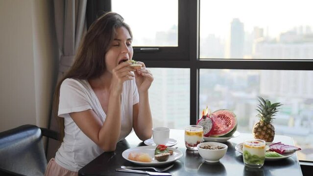 Woman is eating fresh, healthy and tasty food for breakfast at morning