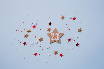Greeting card for the Defender of the Fatherland Day. White, gold, red stars and the number 23 on a light blue background. The holiday is February 23.