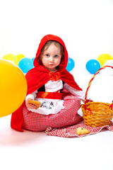 Little girl dressed as a red riding hood on white background. Carnival, Purim, Halloween