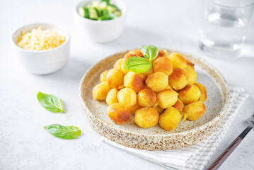 Fried potato gnocchi with cheese filling