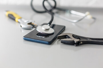 Damaged smartphone and repair tool set on white background, flat lay. Space for text.