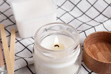 Soy wax candle in glass cup, soy or coconut wax and wicks. Candle making kit. Burning cotton wick closeup