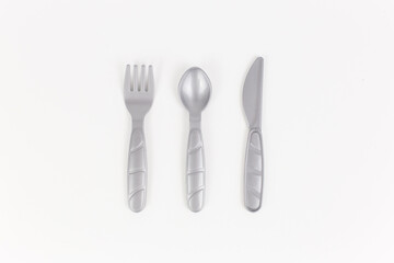 plastic table utensils bottom saw spoon on a white background