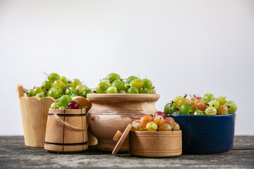 Fresh gooseberries berries in different jars	
