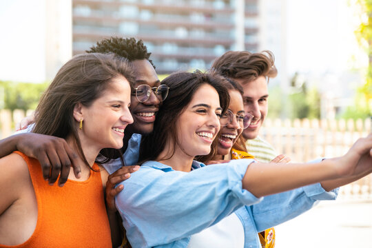 Multiracial group of friends making a selfie with phone in the city - friendship, happiness and joyful concept