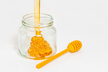 Jar with honey on white background