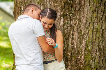 Happy young couple in love outdoors in park