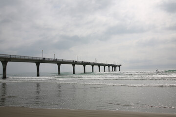 Fototapeta na wymiar ocean pier with cloudy sky