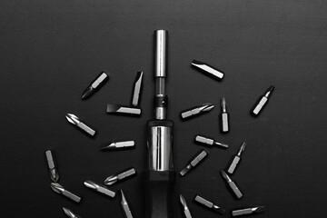 screwdriver tool on black table with accessories