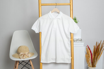 Fototapeta na wymiar The polo shirt mockup displays a tastefully decorated garment, showcasing a simplistic yet stylish design while hanging