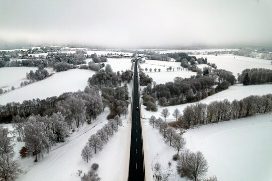 landscape with snow covered trees and road