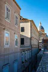 Beautiful Dubrovnik city streets with old houses and vintage balconies suspended above the stone paved streets